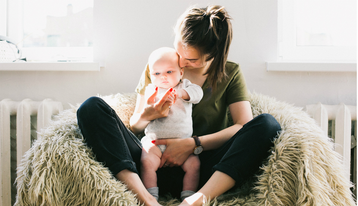 vrouw met baby in haar armen die volgens haar sterrenbeeld de leukste tante is