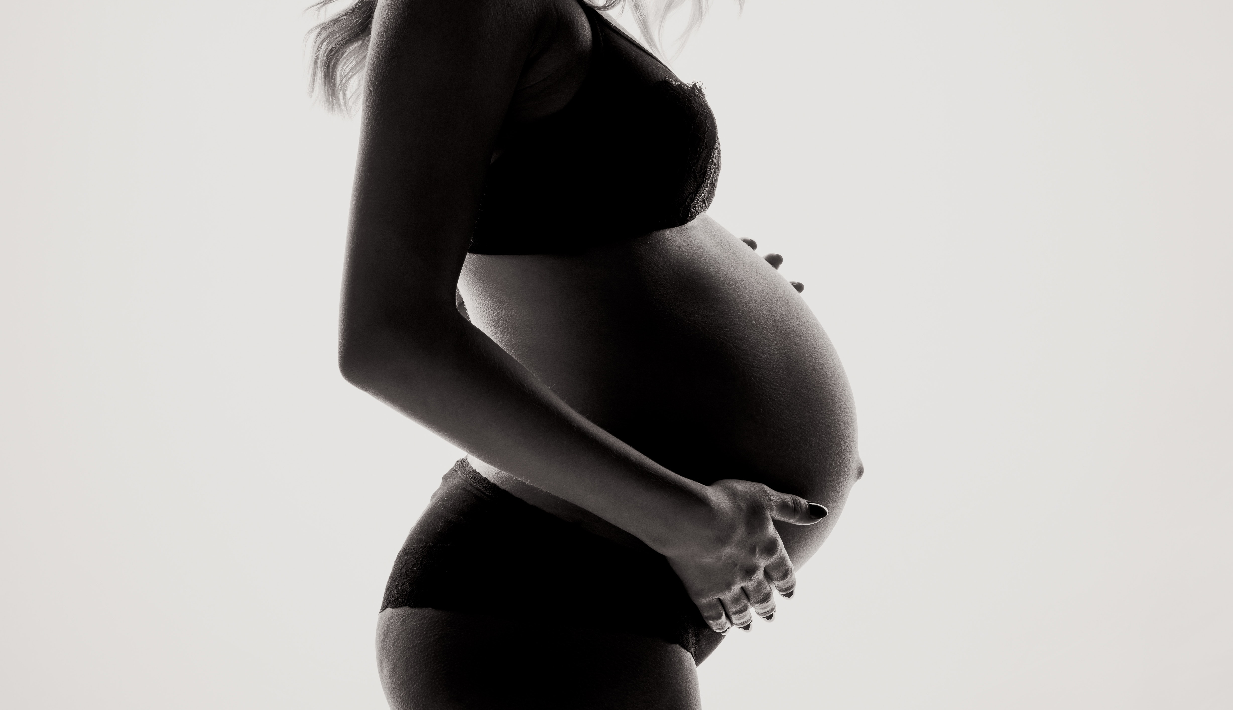 Zwangere vrouw in haar ondergoed